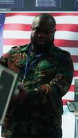 Vertical American military officers in cyber command center protect state secrets, manage classified information and engage in high tech digital warfare to ensure cybersecurity and data protection. Camera B. video