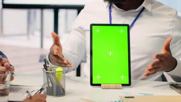 Consultant presents copy space display on tablet to senior clients in office, counseling meeting for retirement and pension plan. Financial adviser helps middle aged people with finances. Camera A. video