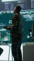 Vertical Team of military specialists operate in a secret service command post, managing surveillance systems and data protection to ensure the safety and security of classified information. Camera B. video