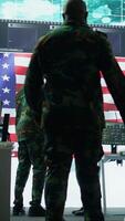 Vertical US soldiers in a high tech command center protecting classified information, ensuring cybersecurity and defending against cyber attacks. Army base of operations with trained officers. Camera B. video