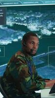 Vertical Soldiers in a modern command center analyze live data from cctv radar sources, satellite feeds and surveillance systems. Intelligence to support strategic planning and military operations. Camera B. video