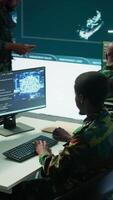 Vertical IT software engineer collecting real time data from neural network AI brain, machine learning and data mining algorithms to assist troops with defense missions. Cognitive computing. Camera B. video