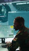 Vertical Soldiers in a state of the art military control room collaborate on data analysis, intelligence gathering, and mission planning. Ensure effectiveness and security of military operations. Camera B. video