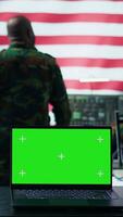 Vertical US army working in a top secret control center with isolated mockup screen, ensuring national safety while studying surveillance footage from radar cctv. Command service. Camera B. video