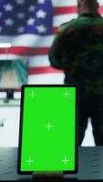 Vertical US military working in a control center with isolated mockup, soldiers examining satellite footage for clues regarding security protocols. American army command post for surveillance. Camera B. video