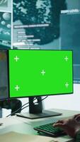 Vertical Army officer gathers intelligence from radar next to isolated copy space, working on satellite data monitoring from control room. Employs high tech gear and big screen in command post. Camera B. video