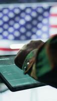 Vertical US soldiers in a cyber control center engaging in cybersecurity operations, handles classified information and ensures security of state secrets and government data. Surveillance footage. Camera B. video