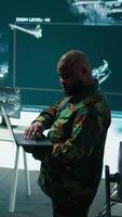 Vertical Military specialists work in a high tech command post center, focusing on cybersecurity, surveillance and data protection to ensure the security and integrity of national information. Camera B. video