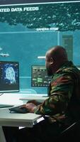 Vertical Cloud computing expert using new technology AI brain to learn intelligence for national defense missions, operating laptop to gather information from cctv systems. Neural network. Camera B. video