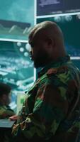Vertical Cybersecurity team operates in an advanced military command center, surveillance systems and data protection. Army personnel work on national security operations using high tech gear. Camera B. video
