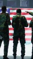 Vertical US soldiers in a high tech command center protecting classified information, ensuring cybersecurity and defending against cyber attacks. Army base of operations with trained officers. Camera A. video