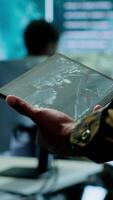 Vertical Military officer leads cybersecurity operations in a high tech operation room command post, ensuring data protection. Soldiers working with cctv surveillance systems, satellite imagery. Camera A. video