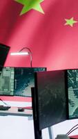 Vertical Military analyst from China reviews surveillance data in an army monitoring room headquarters. Chinese soldiers spreading misinformation through propaganda, presenting the national flag. Camera A. video