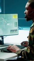 Vertical Army intelligence specialist utilize advanced computer systems, surveillance technology and data to enhance national security. Working in a command post against potential threats. Camera A. video