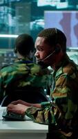 Vertical Soldiers in a state of the art military control room collaborate on data analysis, intelligence gathering, and mission planning. Ensure effectiveness and security of military operations. Camera A. video