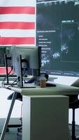 Vertical Empty army command center with big data presents the American flag, top secret armed forces agency protecting the country from threats. Monitoring room with high tech gear. Camera A. video