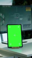 Vertical Soldier gathering real time surveillance data next to mockup display in high tech command center, processing intelligence for field operations. Working with modern gear and big screen. Camera A. video