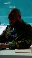 Vertical Intelligence agents in modern operations center managing surveillance activity and synchronizing security protocols. Army base staff interpret real time data to protect national interests. Camera A. video