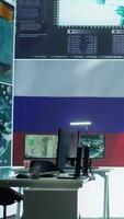 Vertical Empty army command center monitoring room agency with the russian flag on big screen, spreading propaganda messages and fake news to scare people. Military Russian federation power. Camera B. video