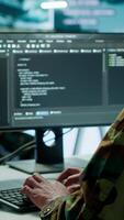 Vertical Soldier working with AI intelligence on pc in control room, processing live data on cctv systems. Surveillance efforts to support field missions and defense operations, national security. Camera A. video