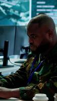 Vertical Team of military professionals in control center monitors satellite intelligence, collecting real time information and transmitting details for a mission success. Decision making. Camera A. video