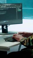 Vertical IT expert monitors AI brain intelligence system to collect crucial real time data for a new defense military operation on pc in command post. Security protocols for an intense mission. Camera A. video