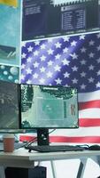 Vertical Empty operation room with an American flag running on big screen in control tower, protecting classified information and state secrets. Military command post fights for anti terrorism. Camera B. video