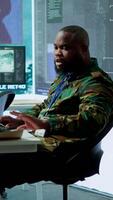 Vertical Army intelligence specialists using advanced computer systems and satellite data to enhance national security, critical information. Soldiers planning for mission in high tech control room. Camera A. video
