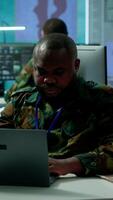 Vertical Military intelligence specialist uses high tech satellite systems and cctv radar to ensure national protocols, strategic missions for defense operation in command post control tower. Camera A. video