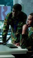 Vertical IT analyst managing satellite radar systems in modern control tower, overseeing intelligence activities and interpreting real time data. National interests for a defense mission. Camera A. video
