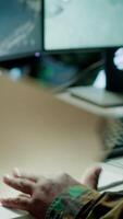 Vertical Military personnel operating in a secure office environment, processing critical information and data on big screen. Maintaining protocols essential for national defense and operations. Camera A. video