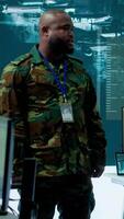 Vertical Military personnel operate advanced systems in a command center, focusing on surveillance and data analysis to protect national security. Soldiers trained to manage information warfare. Camera A. video