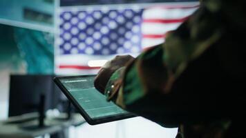 US soldiers in a cyber control center engaging in cybersecurity operations, handles classified information and ensures security of state secrets and government data. Surveillance footage. Camera B. video