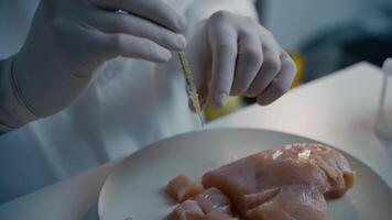 Lab worker injecting medication into meat sample. Genetically modified meat. Artificial meat product, food technology of future. GMO food concept. Male nutrition expert testing food products in lab. video