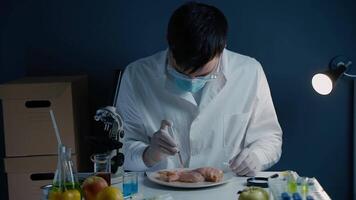 Professional lab worker looking at meat sample through magnifier. Laboratory assistant checks quality of meat at laboratory. Look at chicken through magnifier glass. Meat quality control video
