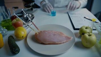 Fresh vegetables, fruits, meat on table and scientist proceeding quality control in laboratory. Genetic engineering laboratory. GMO food concept. Injection into fresh meat. Genetic engineering. video