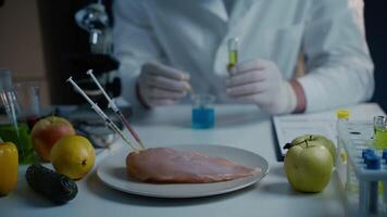 Fresh vegetables, fruits, meat on table and scientist proceeding quality control in laboratory. Genetic engineering laboratory. GMO food concept. Injection into fresh meat. Genetic engineering. video