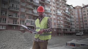 Male builder considers brought building material at construction site, controls materials. Inspector checking and counting building material at site. Supervisor Inspecting insulation for houses. video