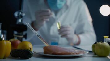 Scientists are testing genetically modified fruits, vegetables, meat for quality, presence of toxins, antibiotics and GMOs in the laboratory. DNA engineering industry. Bio engineering concept. video