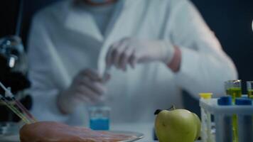 Bioengineering concept. Meat, vegetables and fruits are genetically modified food. Genetically modified food, biotechnology dna manipulation laboratory. Scientist proceeding quality control in lab. video
