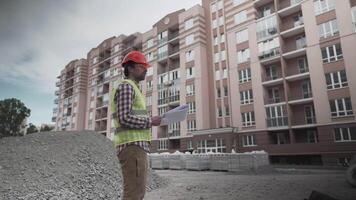 Male builder considers brought building material at construction site, controls materials. Inspector checking and counting building material at site. Supervisor Inspecting insulation for houses. video