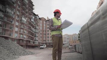 A male construction manager checks the quantity and checks the construction matral with documents at a construction site. Inspector at a construction site at work examines briquettes with insulation. video