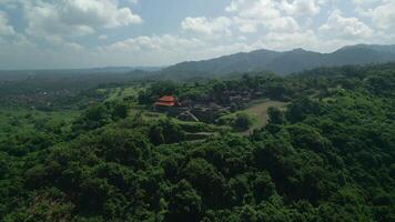 Balinese Temple on the mountain is surrounded by jungle. Indonesia drone view video
