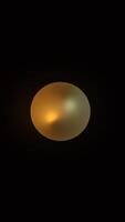 A single, round light fixture hangs in a dark room photo