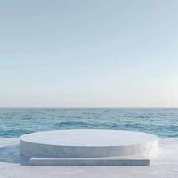 A round podium on the beach, surrounded by sand and sea in light beige tones photo