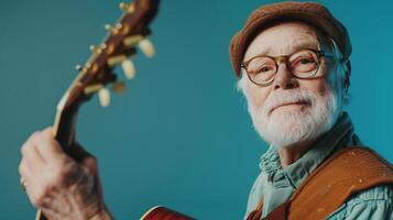 A senior man in a musician's outfit, holding a guitar, Studio Lighting, portrait shot, copy space, flat background photo