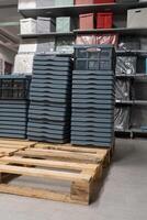 Plastic storage basket, kitchen drawer for storing vegetables. Image of plastic boxes for carrying. Stack of many Plastic Pallets. photo