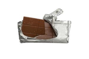 Chocolate wrapped in foil, clipping path, isolated on white background. Top view of a milk chocolate bar in foil. Isolated on a white background. photo