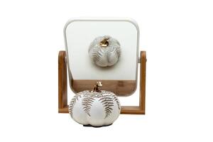 The mirror in which the decorative object is reflected is isolated on a white background. Make-up mirror. Decorative pumpkin. Isolated. photo