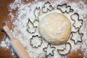 forms for squeezing the dough. dough on the table with dough tools. photo